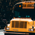A school bus drives on a city street
