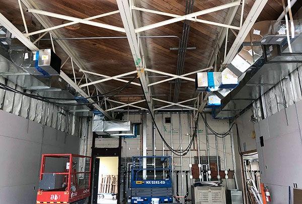 duct work in the ceiling of a large room under construction